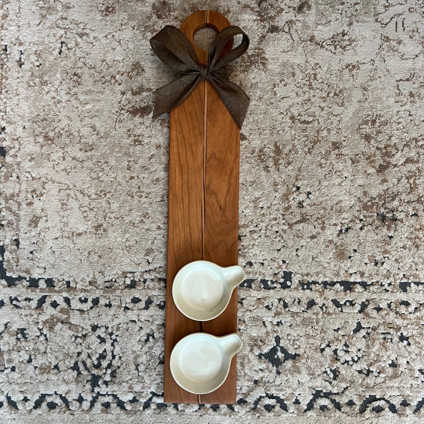 23.5-inch cherry and zebrawood flight board with two white ceramic ramekins and a dark brown bow