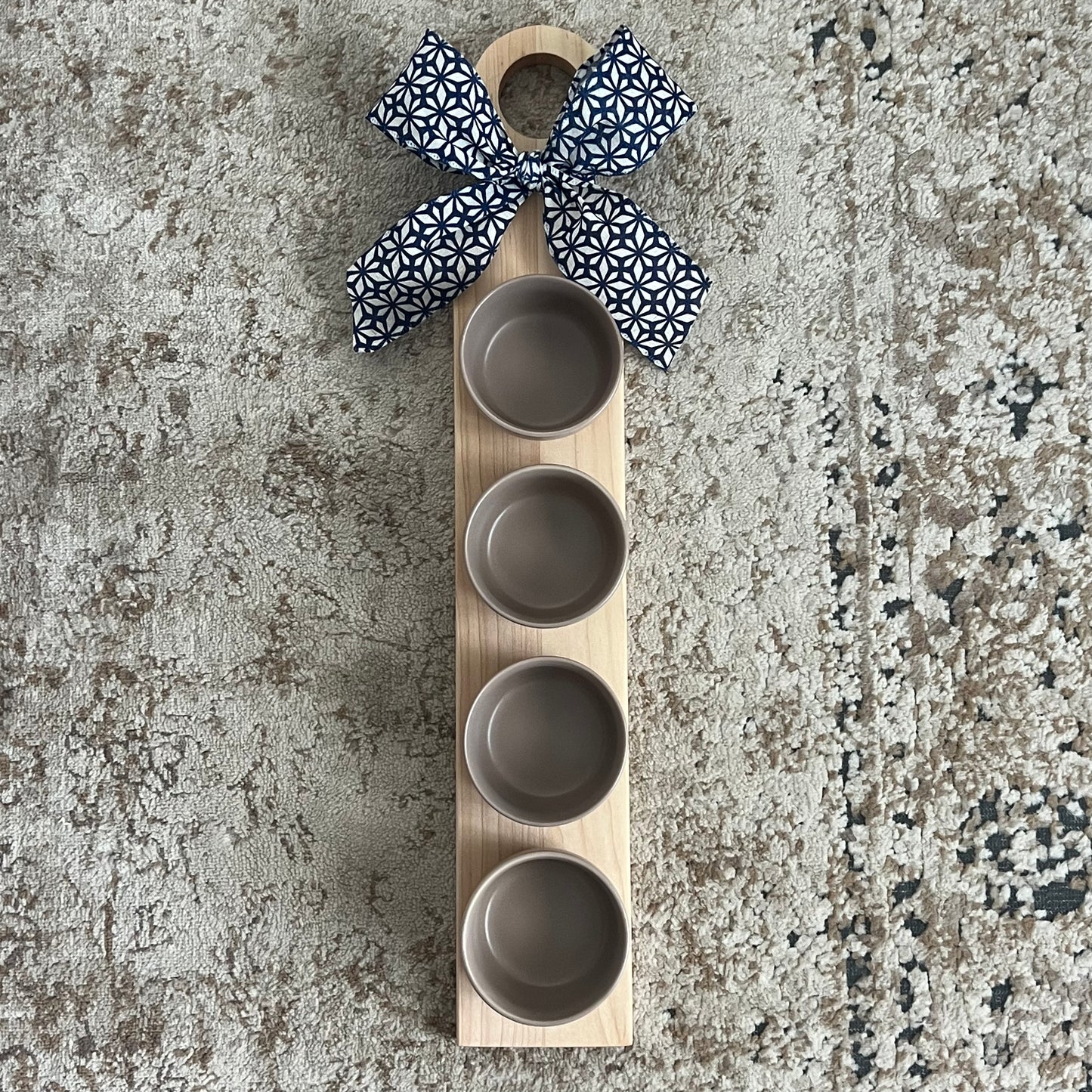 Cherry and maple flight board with 4 tan glass bowls. Approx. 24x4”. Perfect for dips, sauces, and stylish serving. Handcrafted and one of a kind.