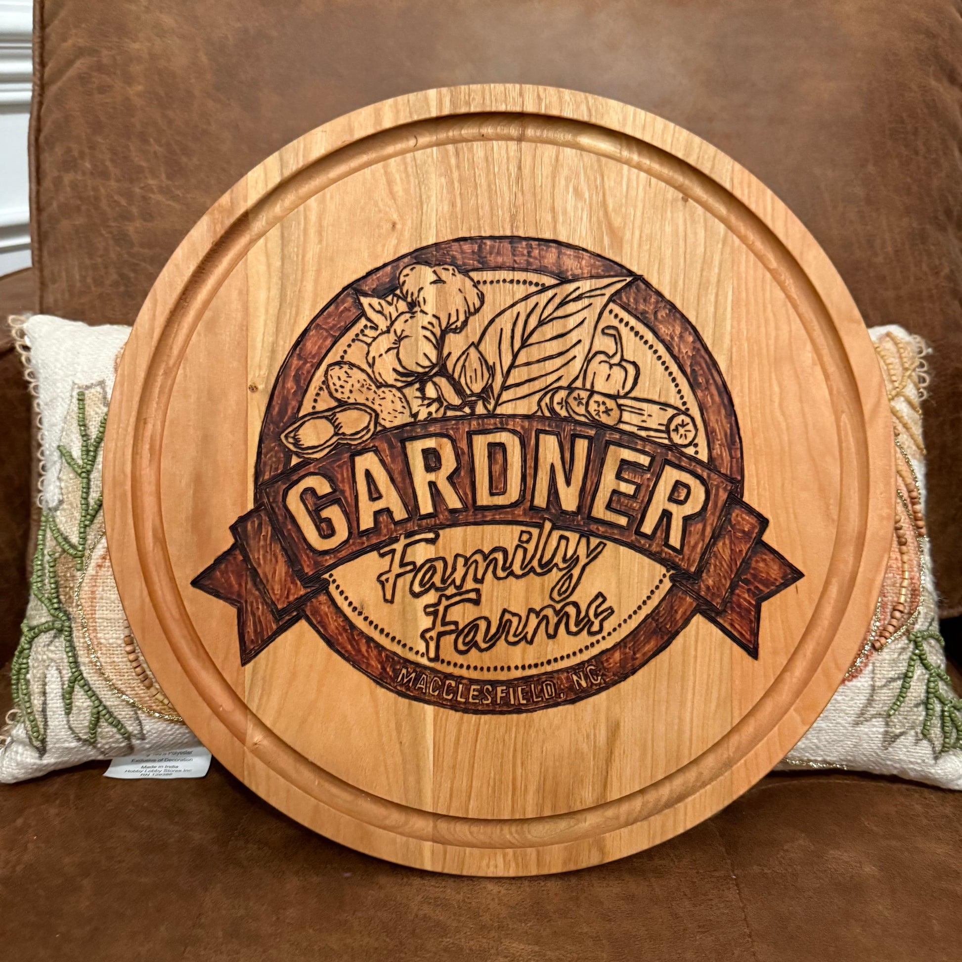 Gardner farms logo on round cherry board