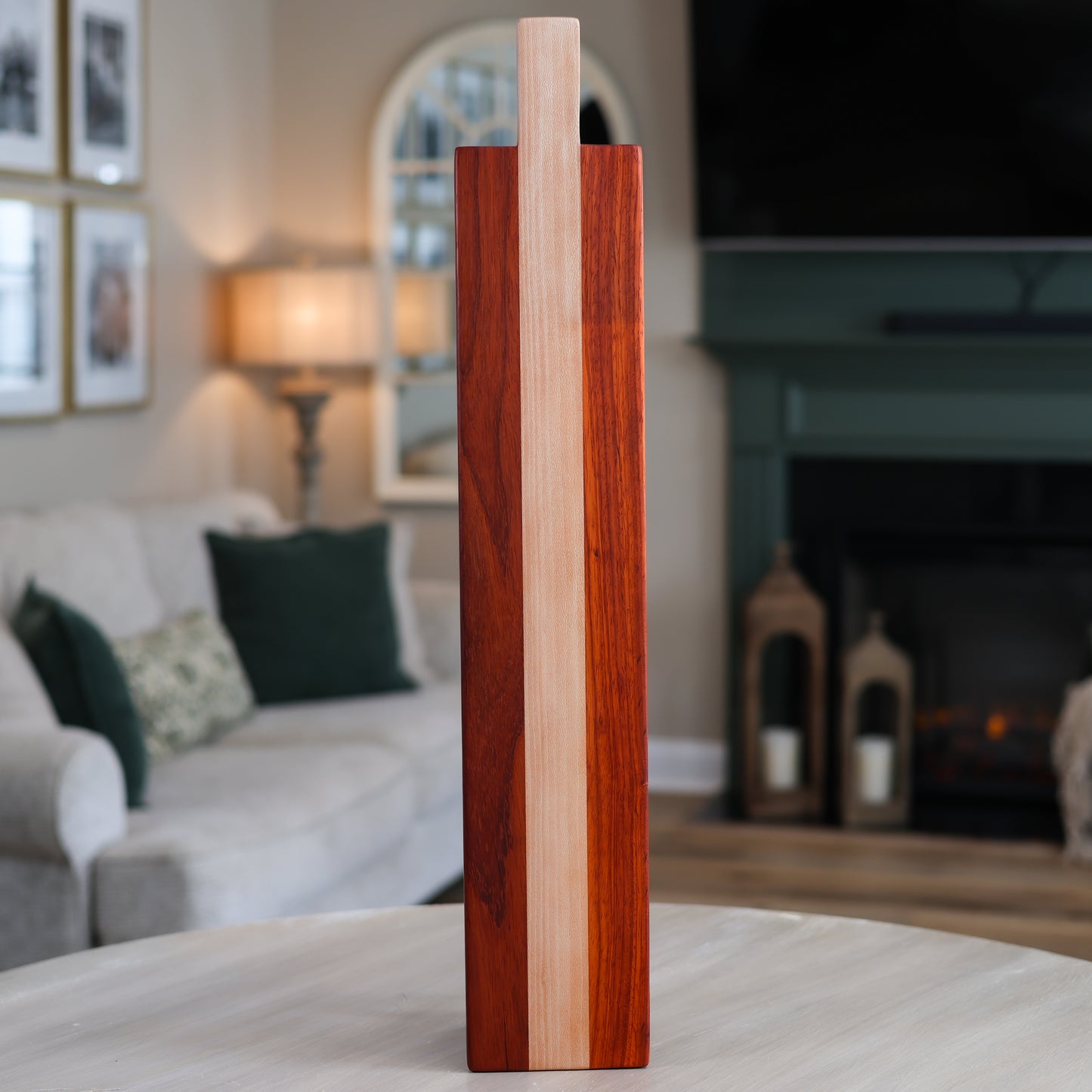 Wooden charcuterie board on a table in a living room setting