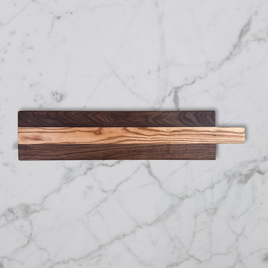 Wooden charcuterie board on a marble surface