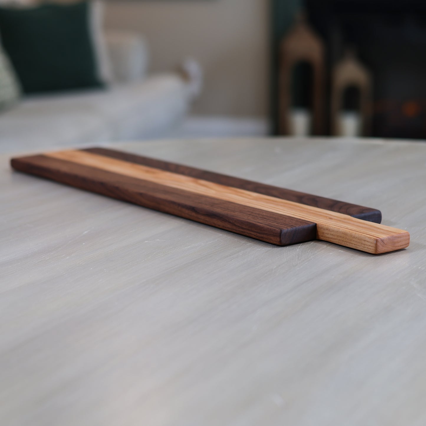 Wooden charcuterie board on a table in a living room