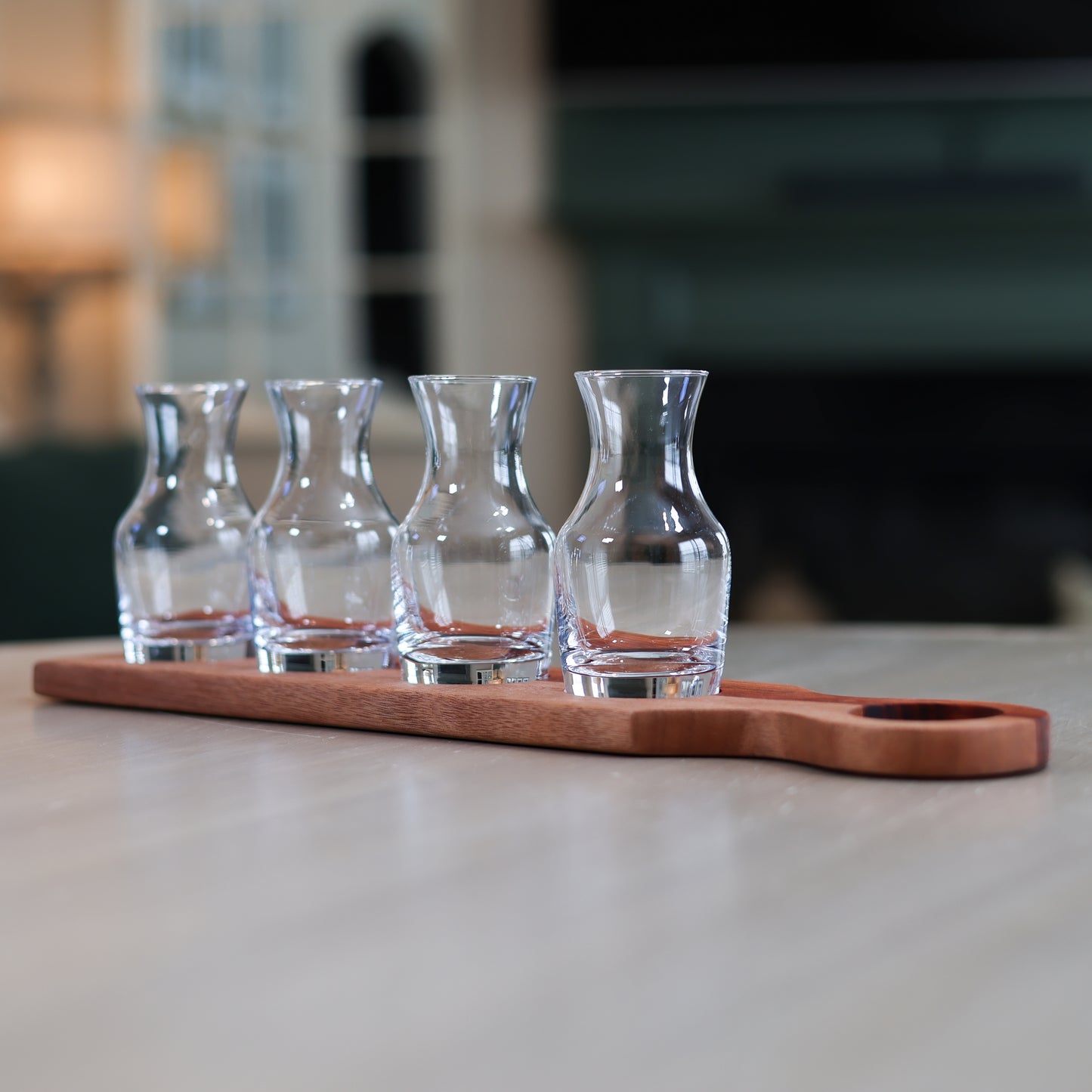 Padauk and okoume wine flight with four glass tasting carafes on wooden board