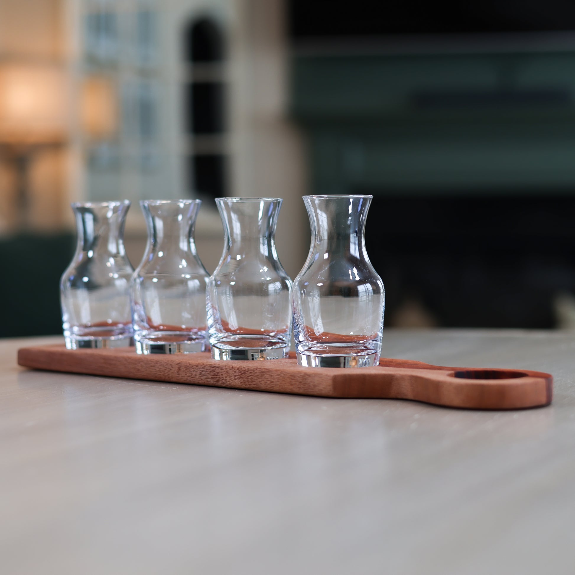 Padauk and okoume wine flight with four glass tasting carafes on wooden board
