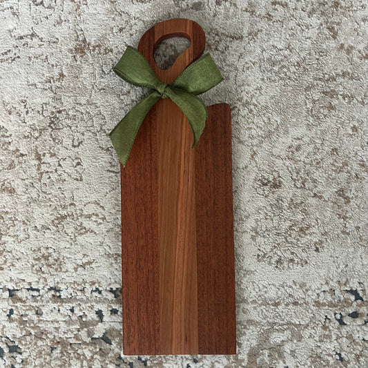 Handcrafted Merbau and Cherry wood bread board with single handle and green decorative bow, featuring rich contrasting tones and smooth finish.