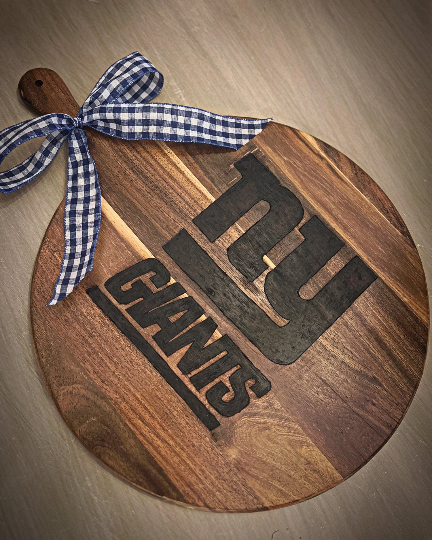 Hand-burned wooden board featuring the New York Giants logo, crafted on natural hardwood with detailed engraving.