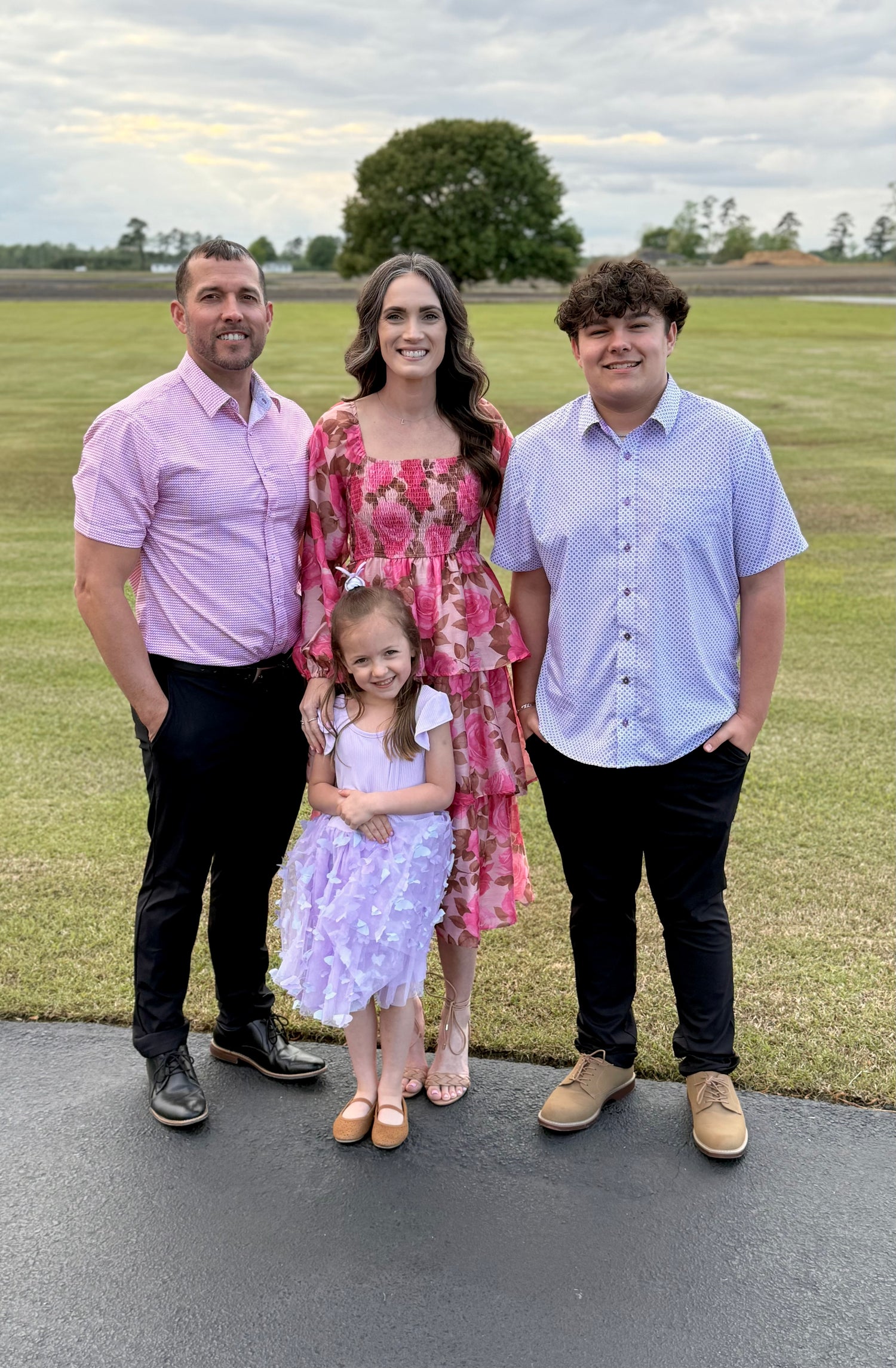 “Cortney, founder of Boards and Bubbles, with her husband and their two children—smiling together outdoors, representing the heart and family behind the business.”