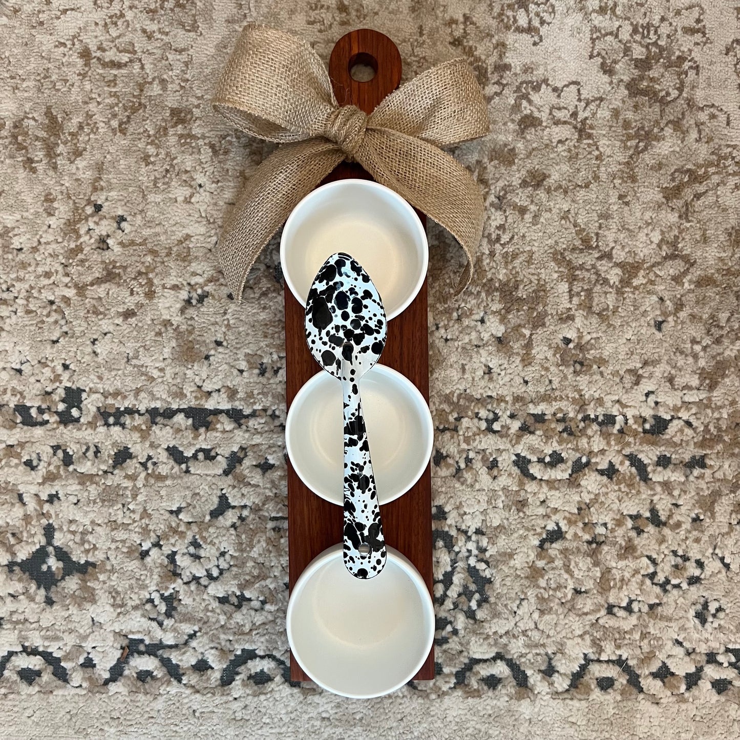 Padauk wood bowl flight with three white ceramic bowls, cowprint enamel spoon, and burlap bow, 17.5" x 4"