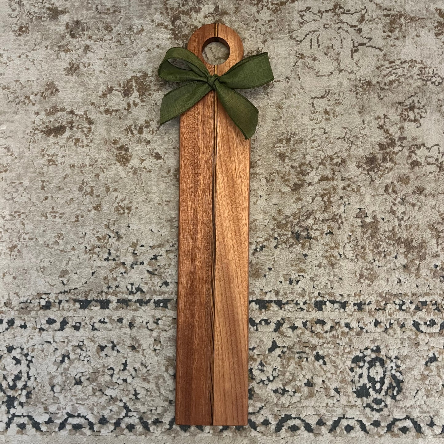 17.5" x 4" handcrafted charcuterie board made of sapele and okoume with zebrawood strip and green bow