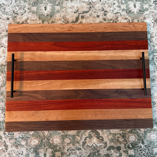 Wooden cutting board with striped pattern on a textured surface