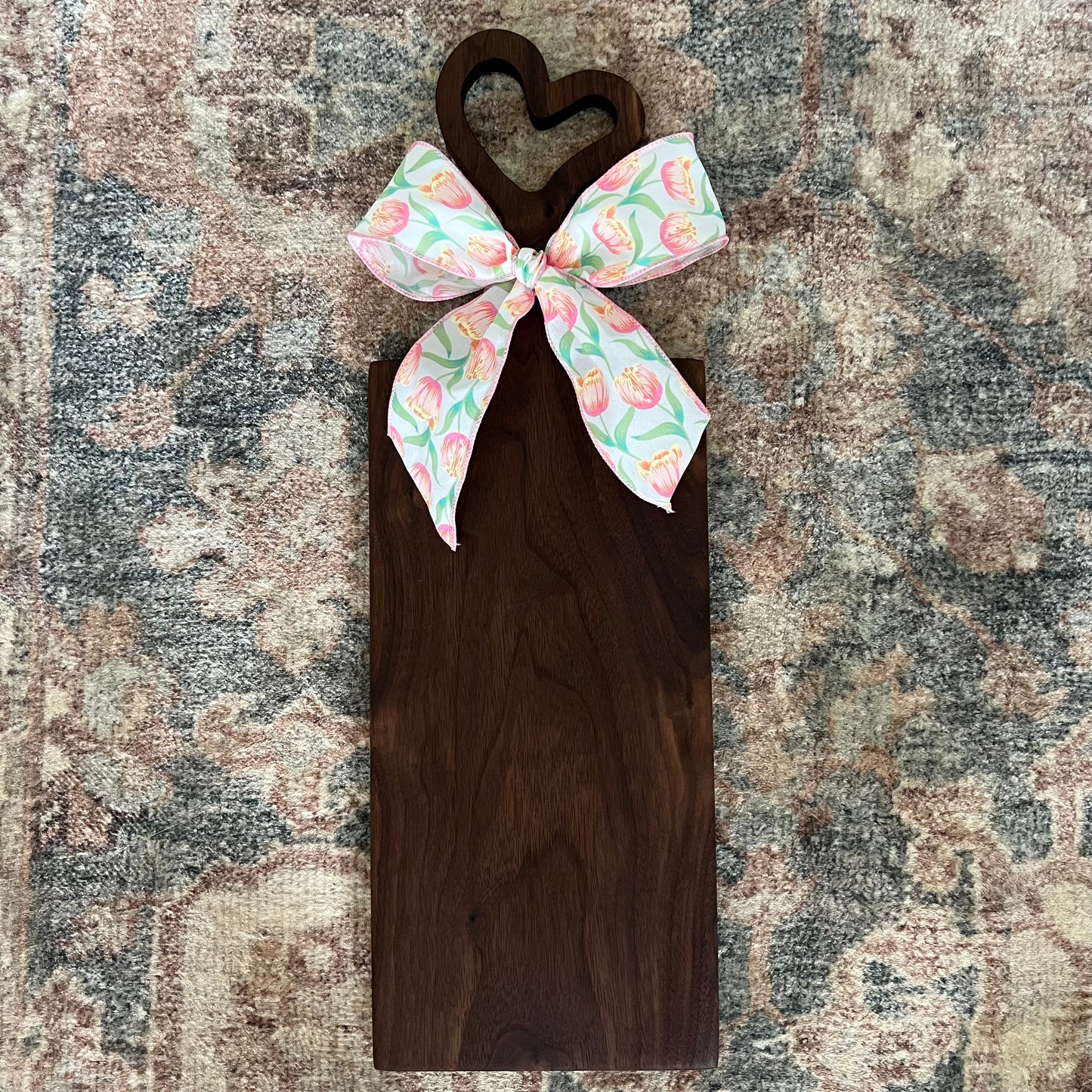 Handcrafted walnut charcuterie board with heart-shaped handle, 23.5 inches tall by 8 inches wide