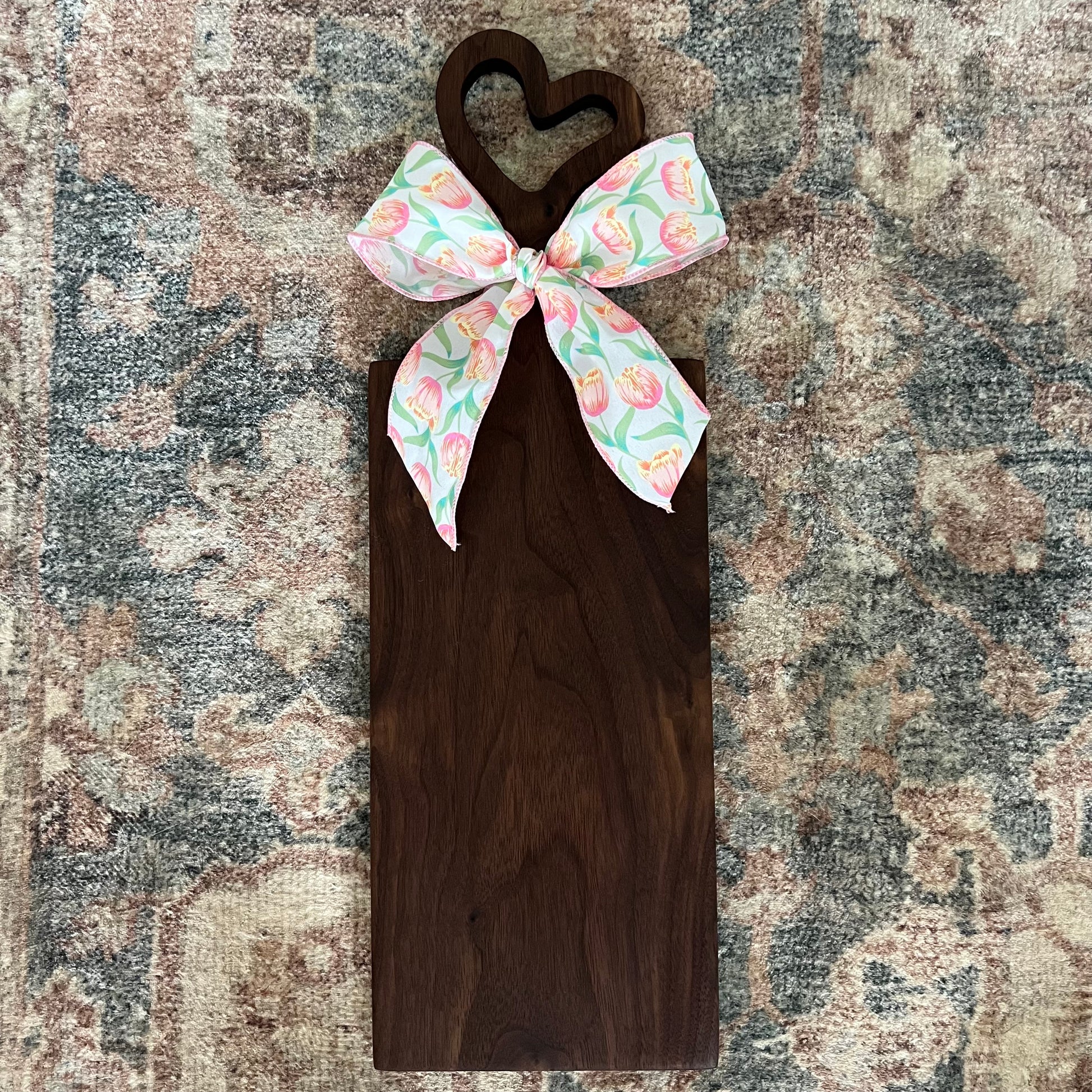 Handcrafted walnut charcuterie board with heart-shaped handle, 23.5 inches tall by 8 inches wide