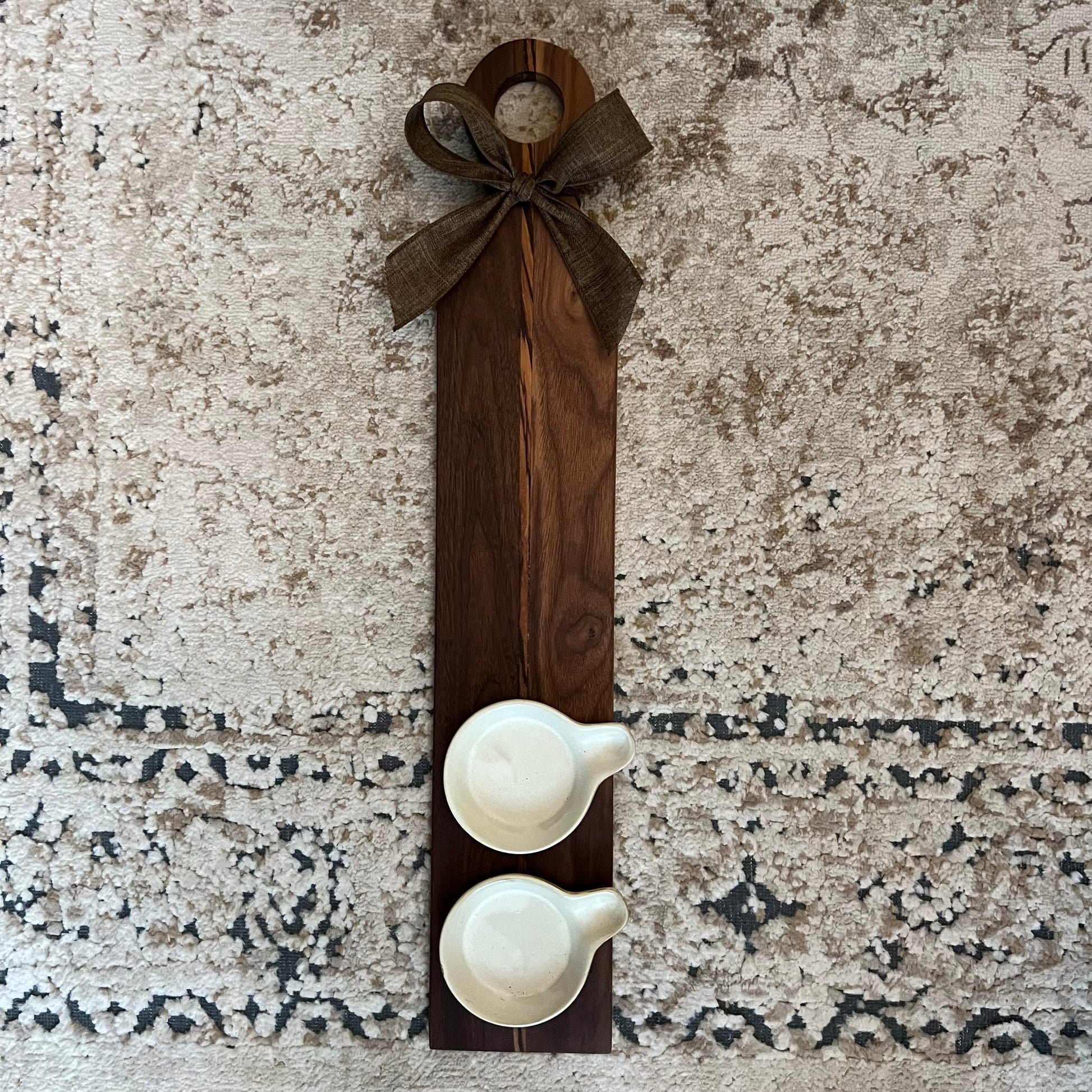 Walnut and zebrawood oil and vinegar flight board with two ceramic ramekins and brown bow, 23.5" x 4.5"