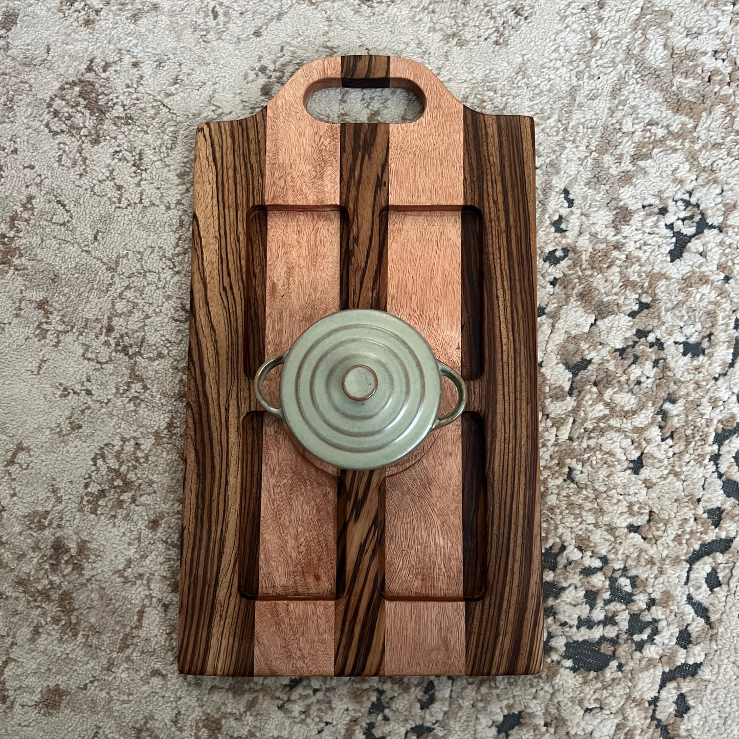 Handcrafted zebrawood and okoume woven board with handle and included mini sage green Dutch oven
